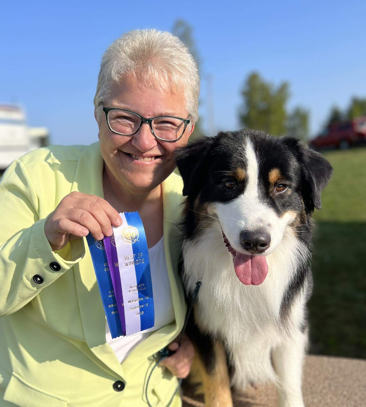 Rocket, a black tri Australian Shepherd, with Ellen and a Best of Winners ribbon